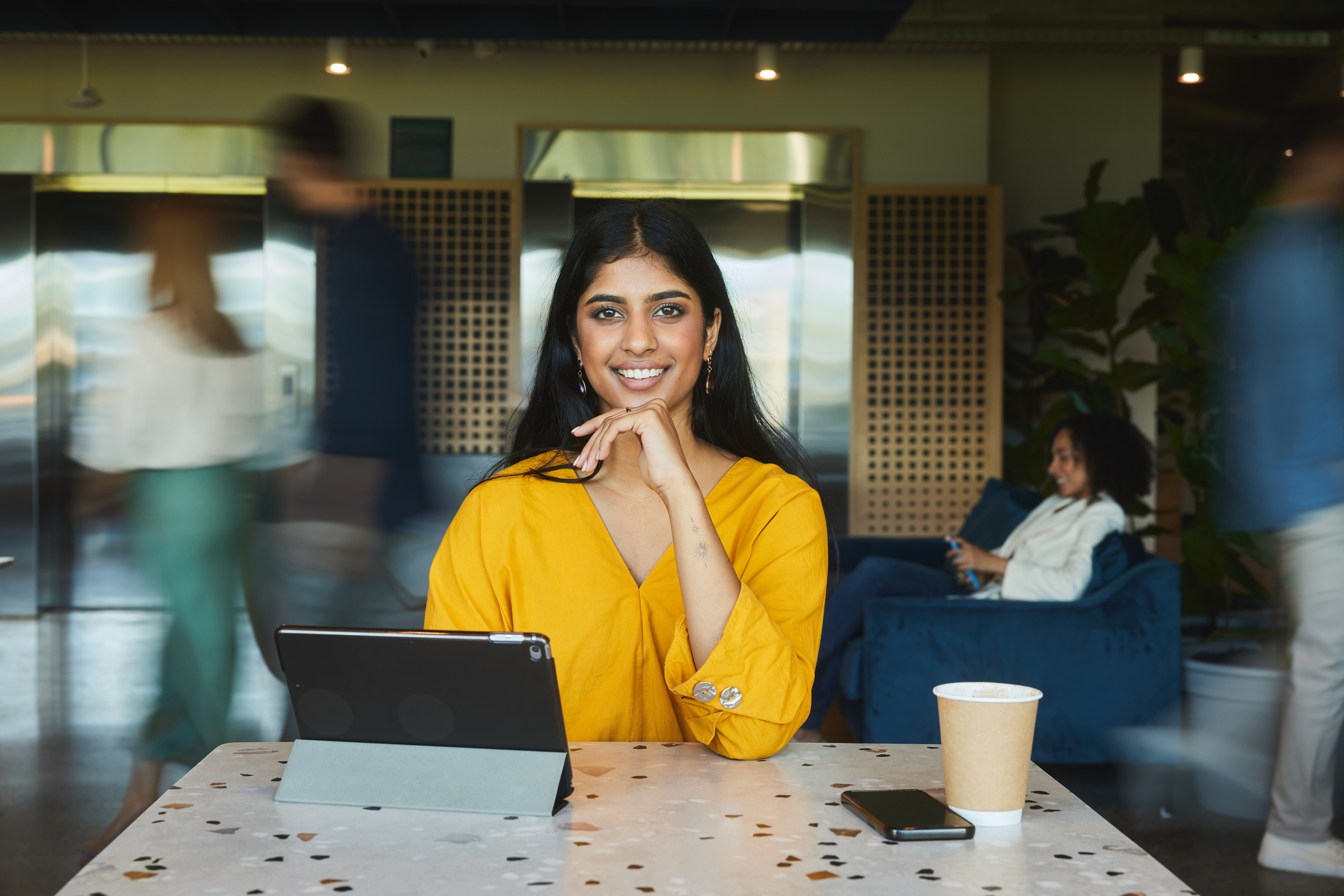 GettyImages 2027483775 1 happy business woman at coffee shop