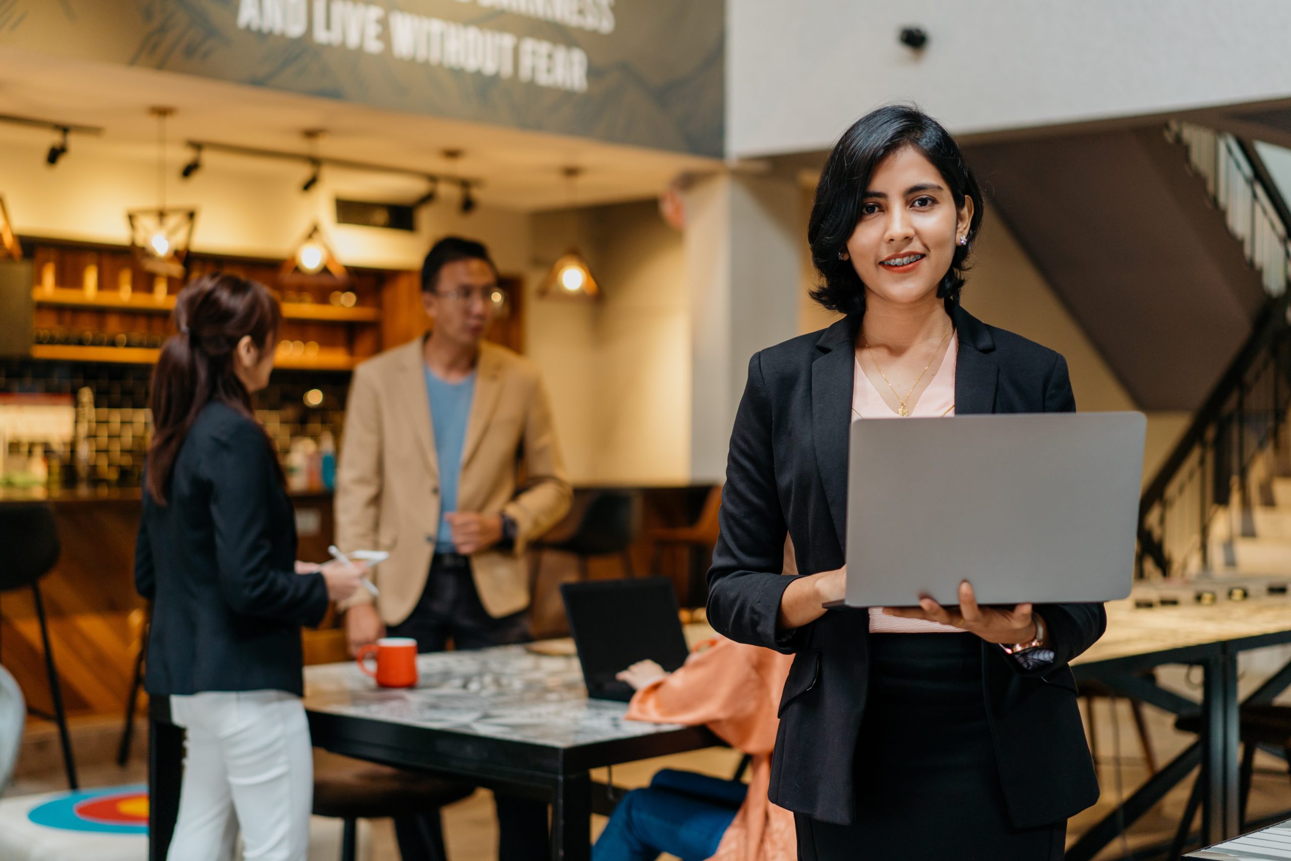Confidence Indian businesswoman using laptop in co working space