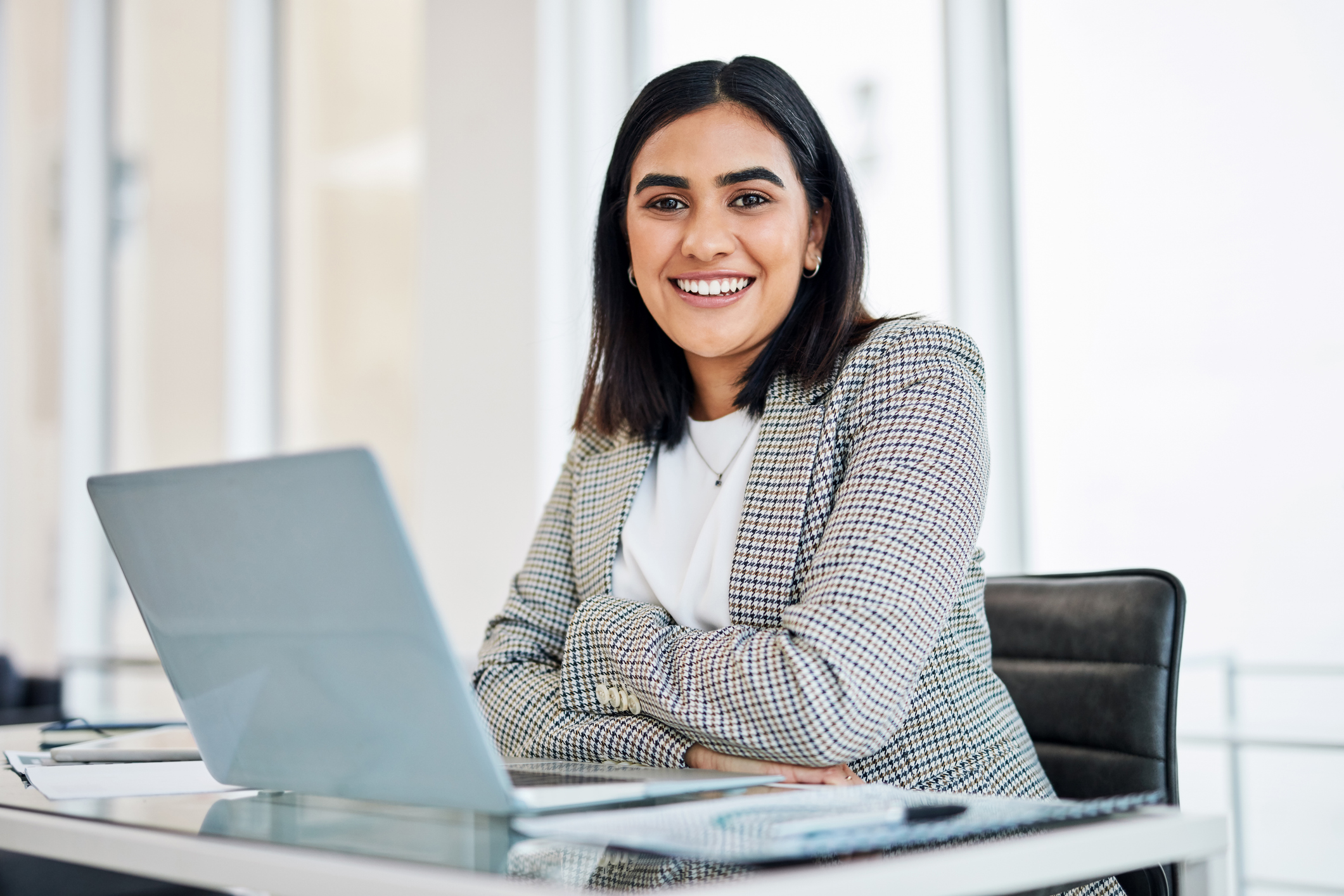 Portrait of a young businesswoman working on a laptop in an office